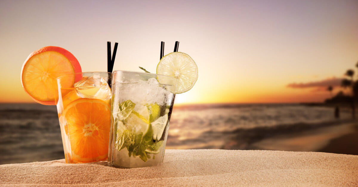 Exotic summer drinks , blur sandy beach on background